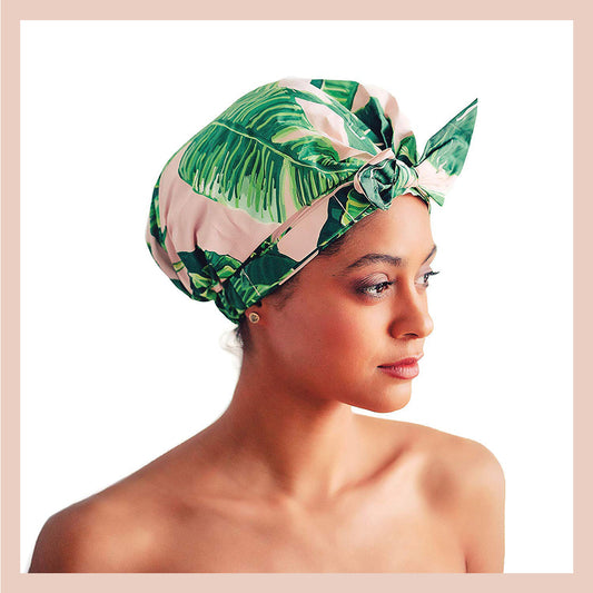 Why a shower cap is a must-have for women with curly hair - image of a woman with a colorful shower cap.